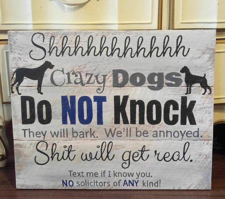 a sign that says don't knock on our door or our dogs will go mad and so will we!